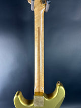 Gold-colored tool on a dark background