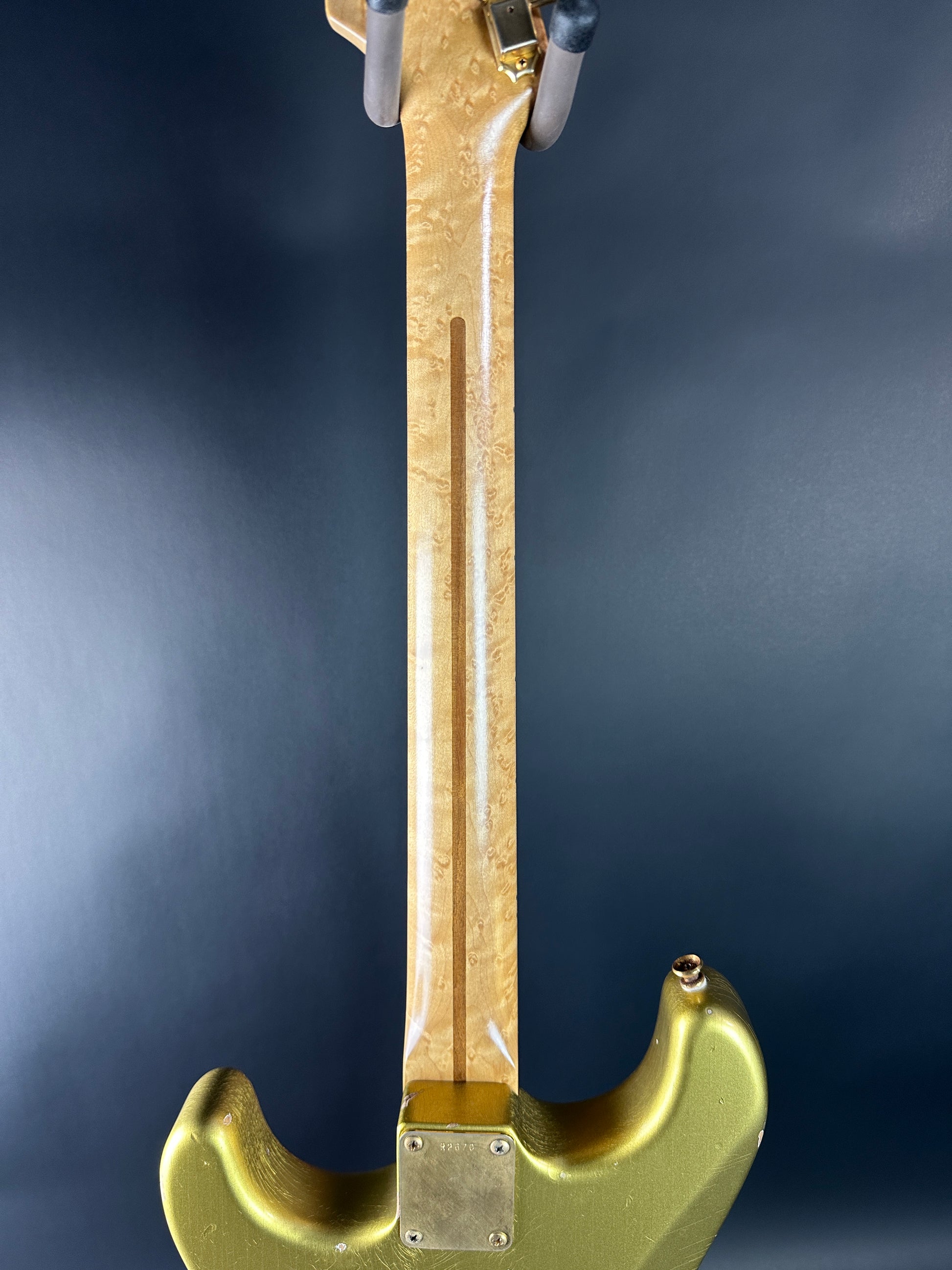 Gold-colored tool on a dark background