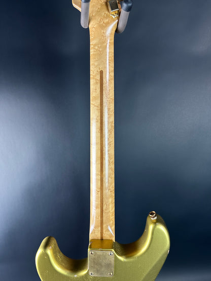 Gold-colored tool on a dark background