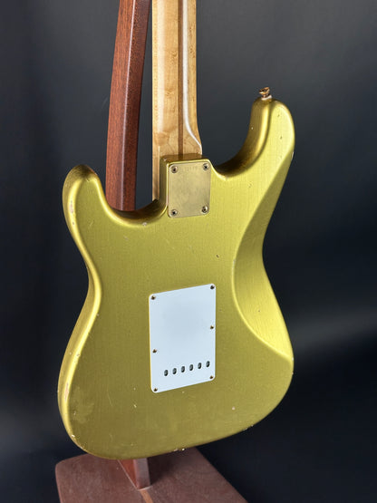 Gold electric guitar body on a dark background
