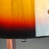 Close-up detail of a sunburst electric guitar body showing the glossy black edge, red and orange gradient, and wood grain.