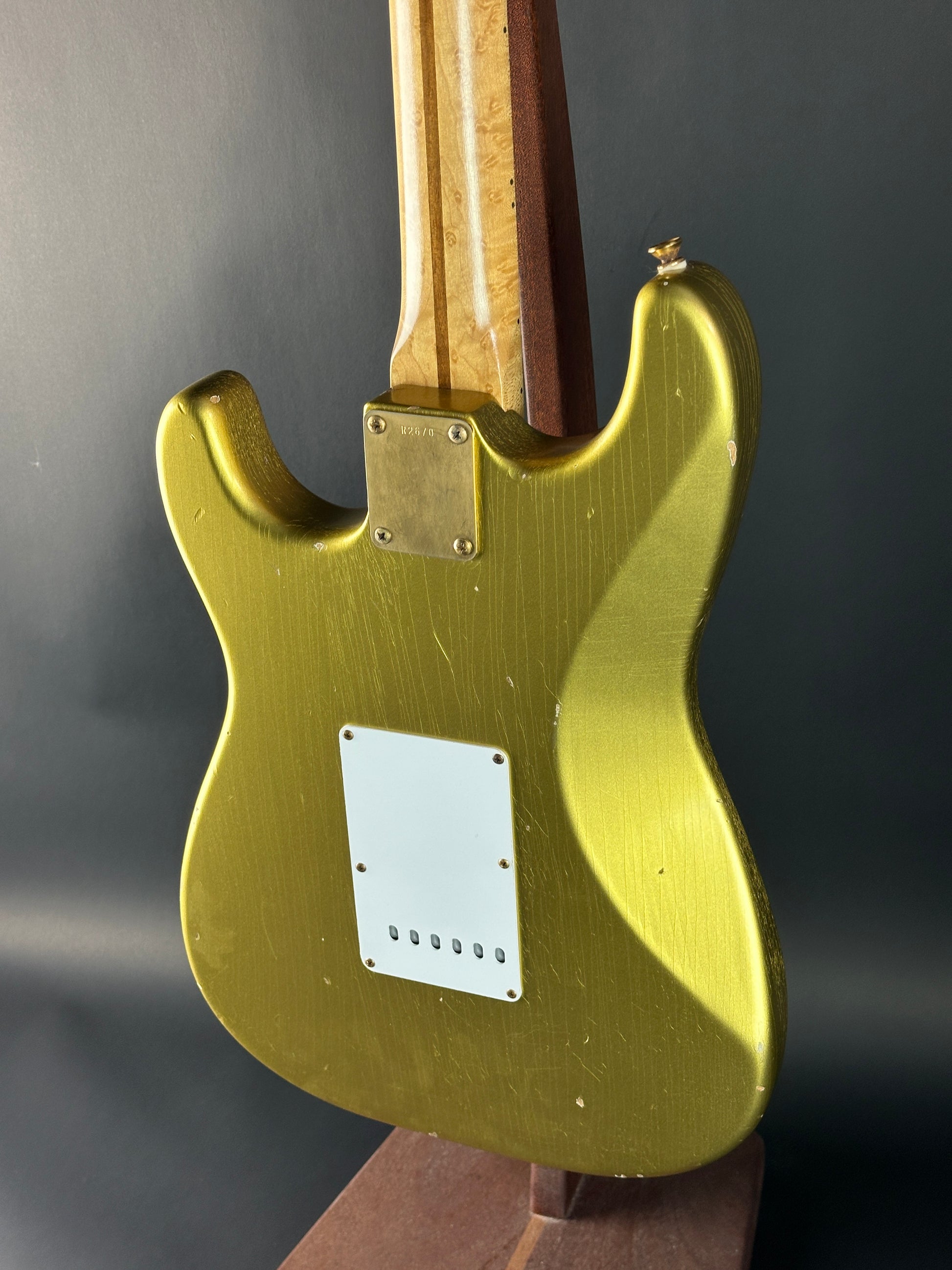 Gold electric guitar body on a dark background