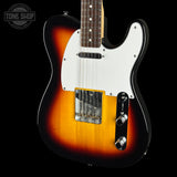 A classic electric guitar with a sunburst finish, featuring a white pickguard, dual humbucker pickups, and a black control plate, shown against a solid black background with a Tone Shop watermark in the top left corner.