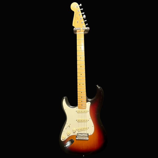 Electric guitar with a sunburst finish on a black background