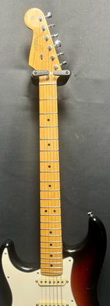 Electric guitar with a sunburst finish on a gray background