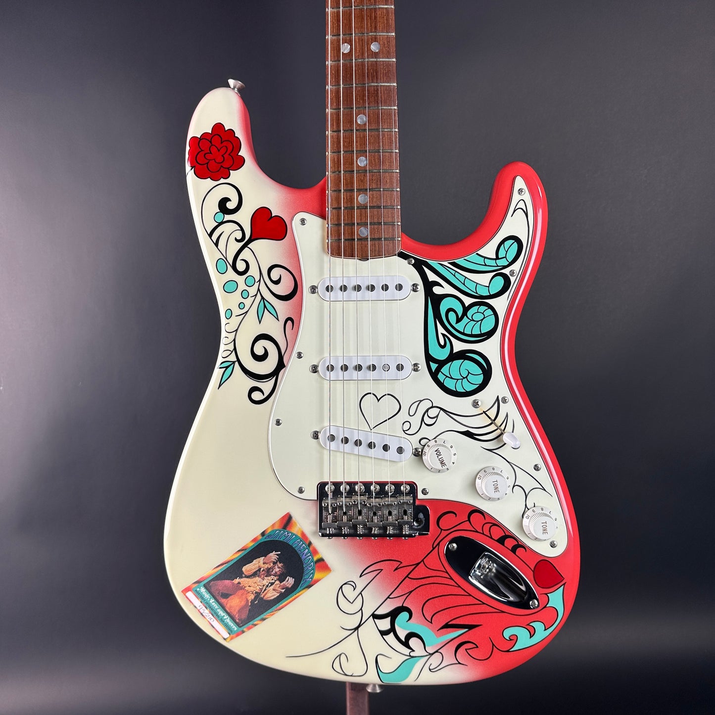 Colorful electric guitar with artistic designs on a dark background