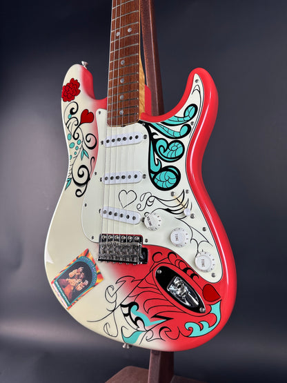 Guitar with colorful design on a dark background