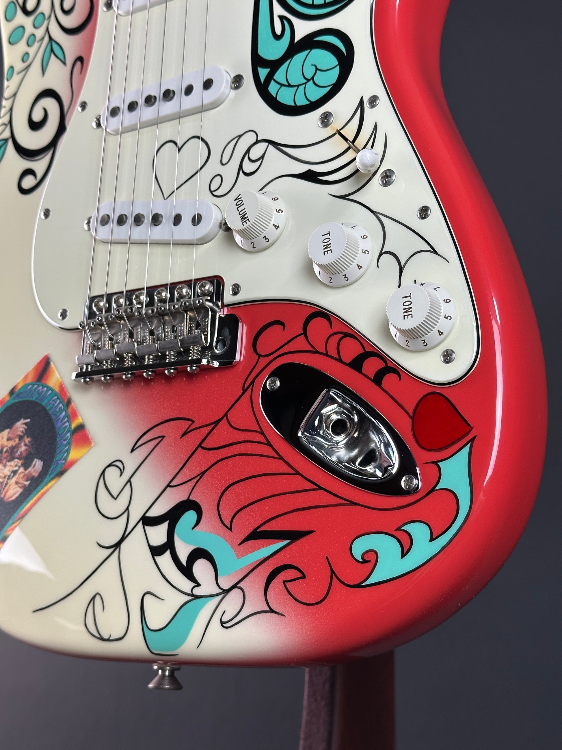Close-up of a guitar with colorful design and visible hardware