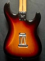 Electric guitar body with a sunburst finish on a dark gray background