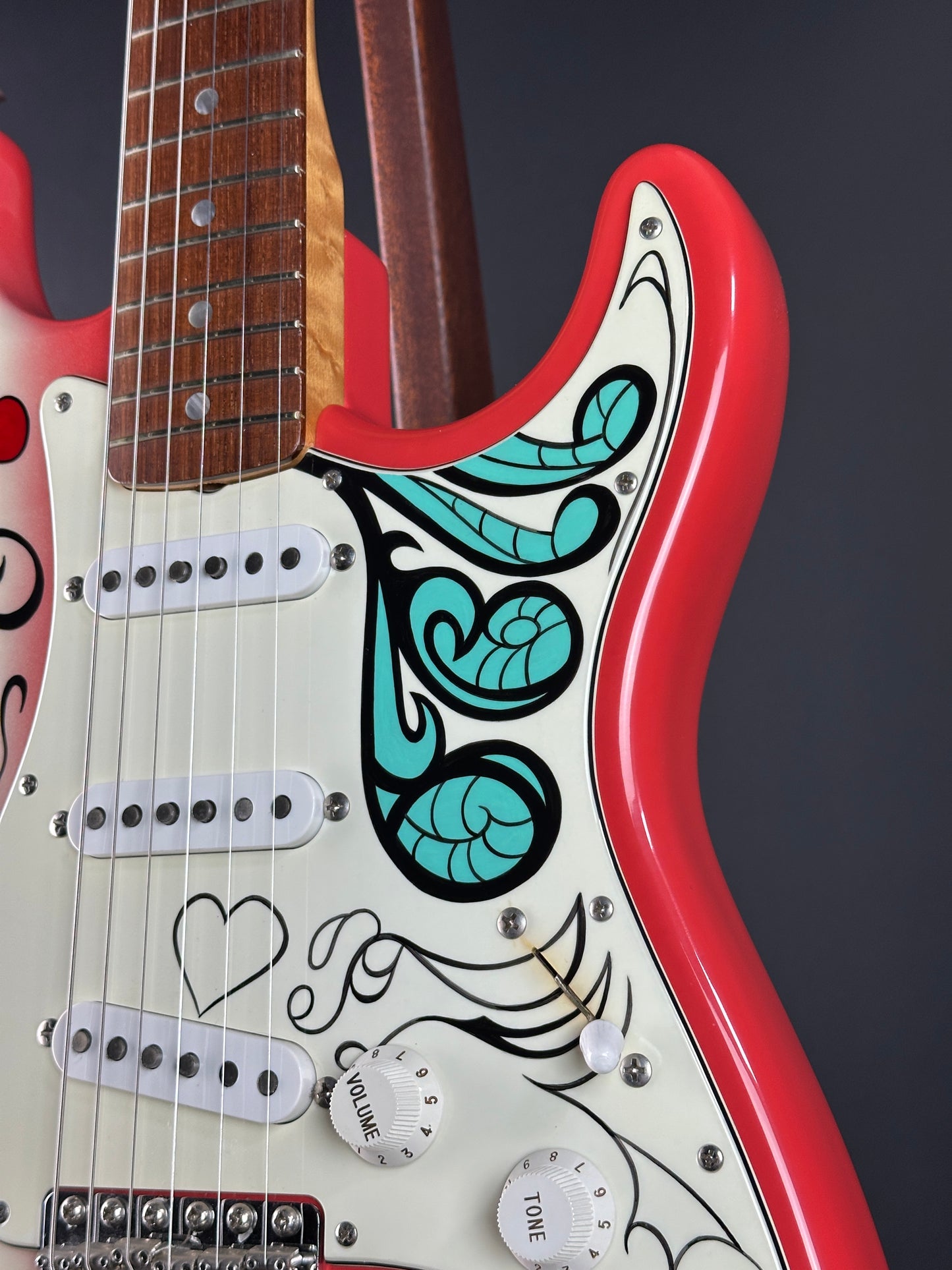 Close-up of a guitar with decorative patterns on a dark background