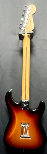 Electric guitar with a sunburst finish on a gray background