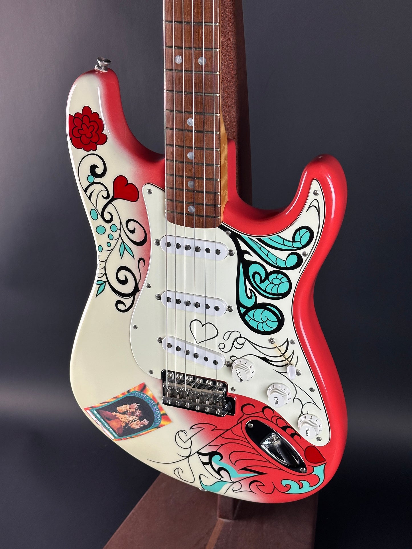 Guitar with colorful designs on a dark background