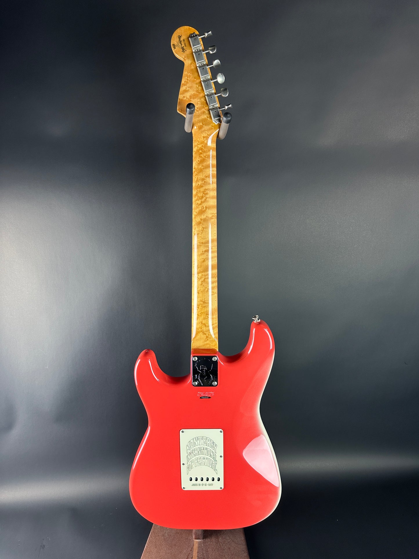 Red electric guitar on a dark gray background