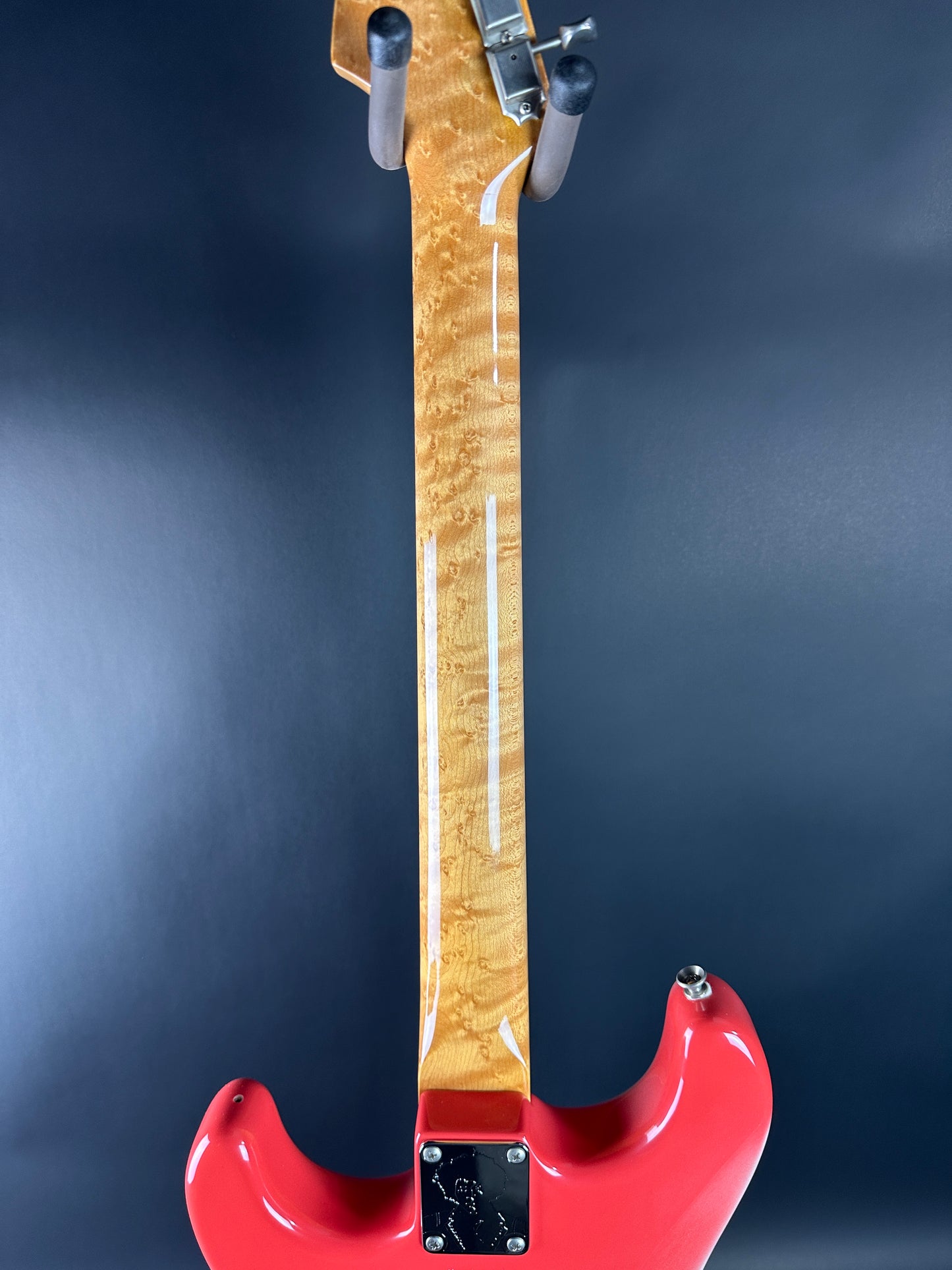 Red electric bass guitar on a dark background