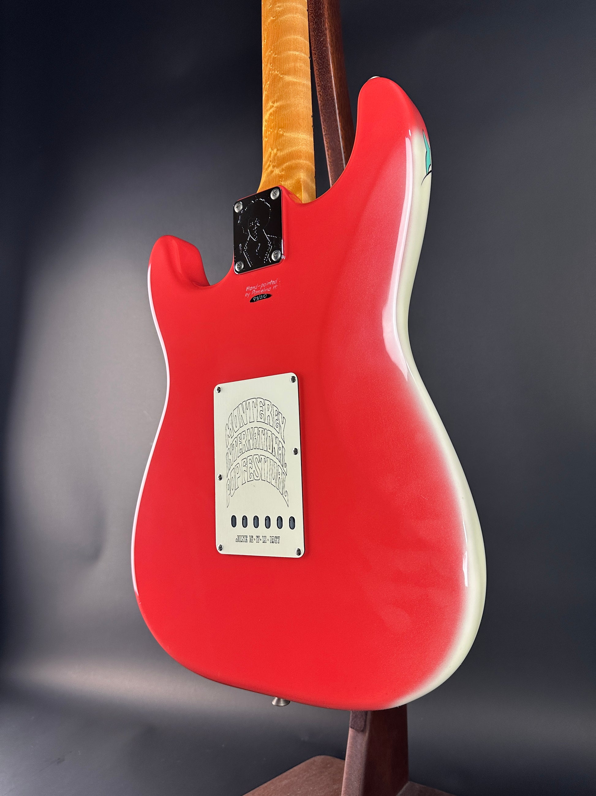 Red electric guitar body with a dark gray background