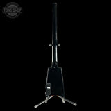 A black electric guitar headstock mounted on a stand, shown from the back against a solid black background. A Tone Shop watermark is visible in the top-left corner.