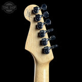 Guitar headstock with tuning pegs on a black background, featuring the Tone Shop logo.
