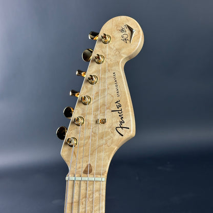Close-up of a Fender guitar headstock on a dark background