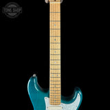 Blue electric guitar with a black background