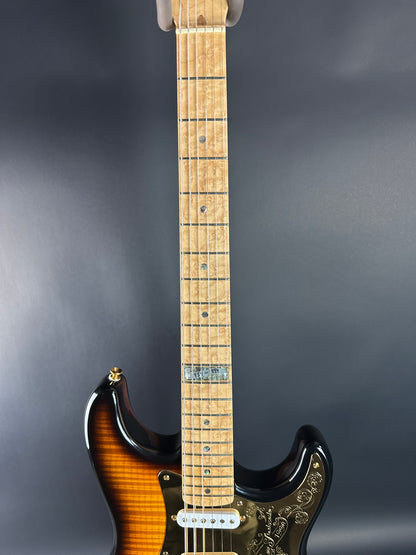 Electric guitar with a sunburst finish on a dark gray background