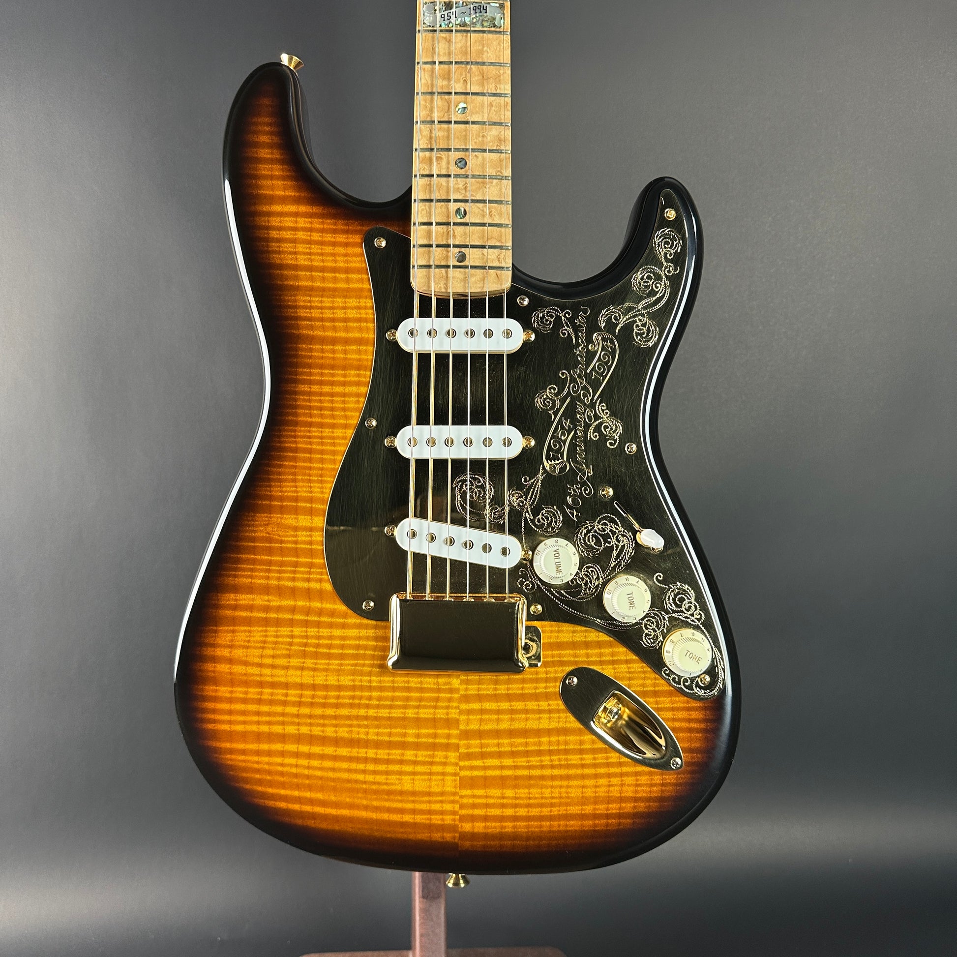 Electric guitar with a sunburst finish on a gray background