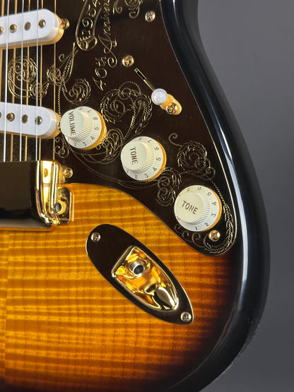 Close-up of a guitar's control knobs and body with a dark background