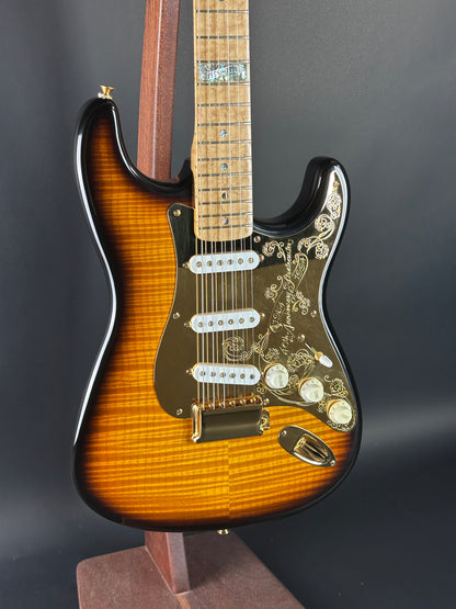 Electric guitar with a sunburst finish on a dark background