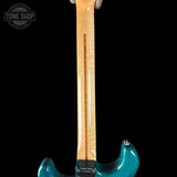 Teal electric guitar with a close-up of the neck on a black background, featuring 'Tone Shop' branding.