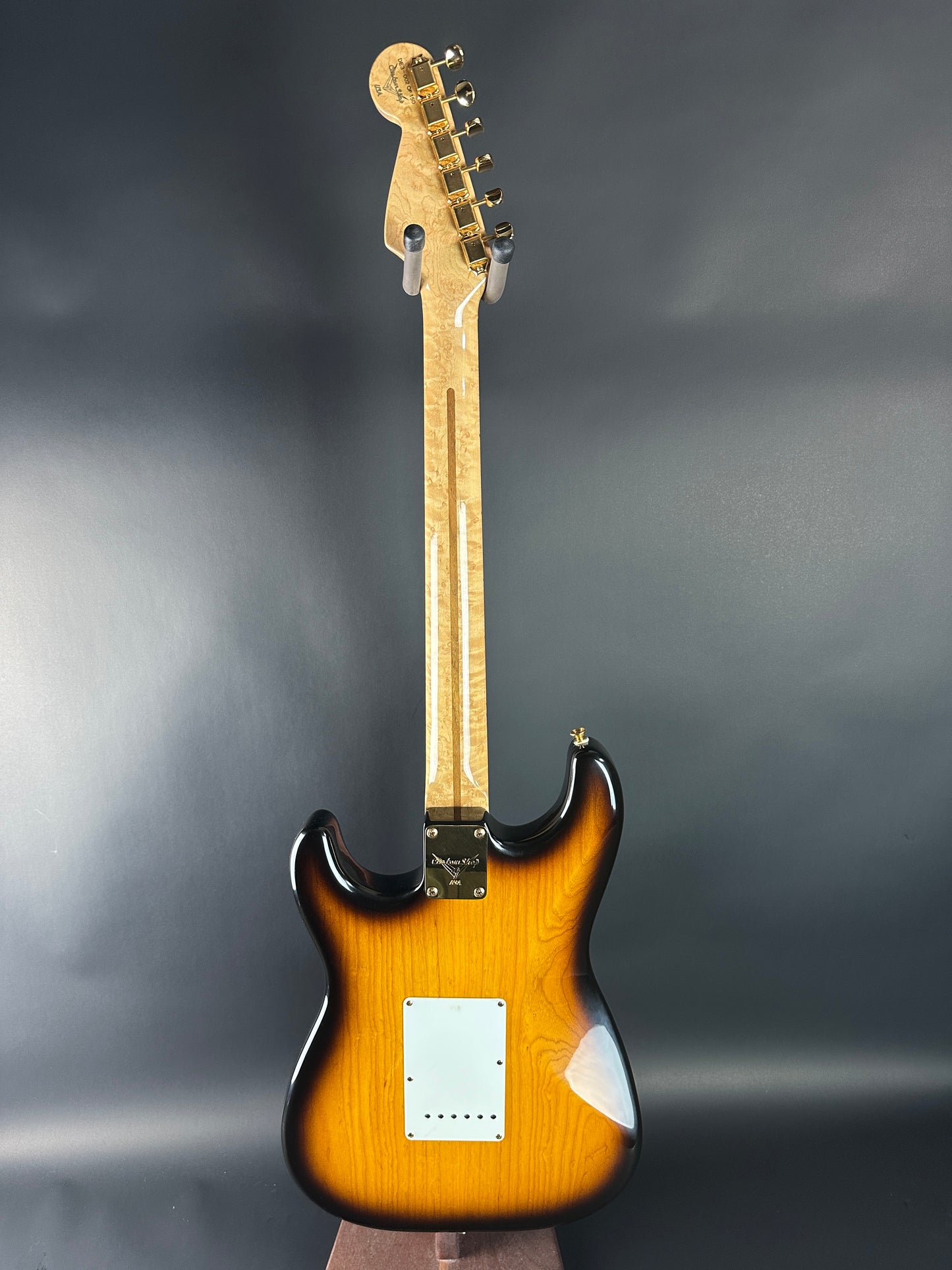 Electric guitar with a sunburst finish on a gray background