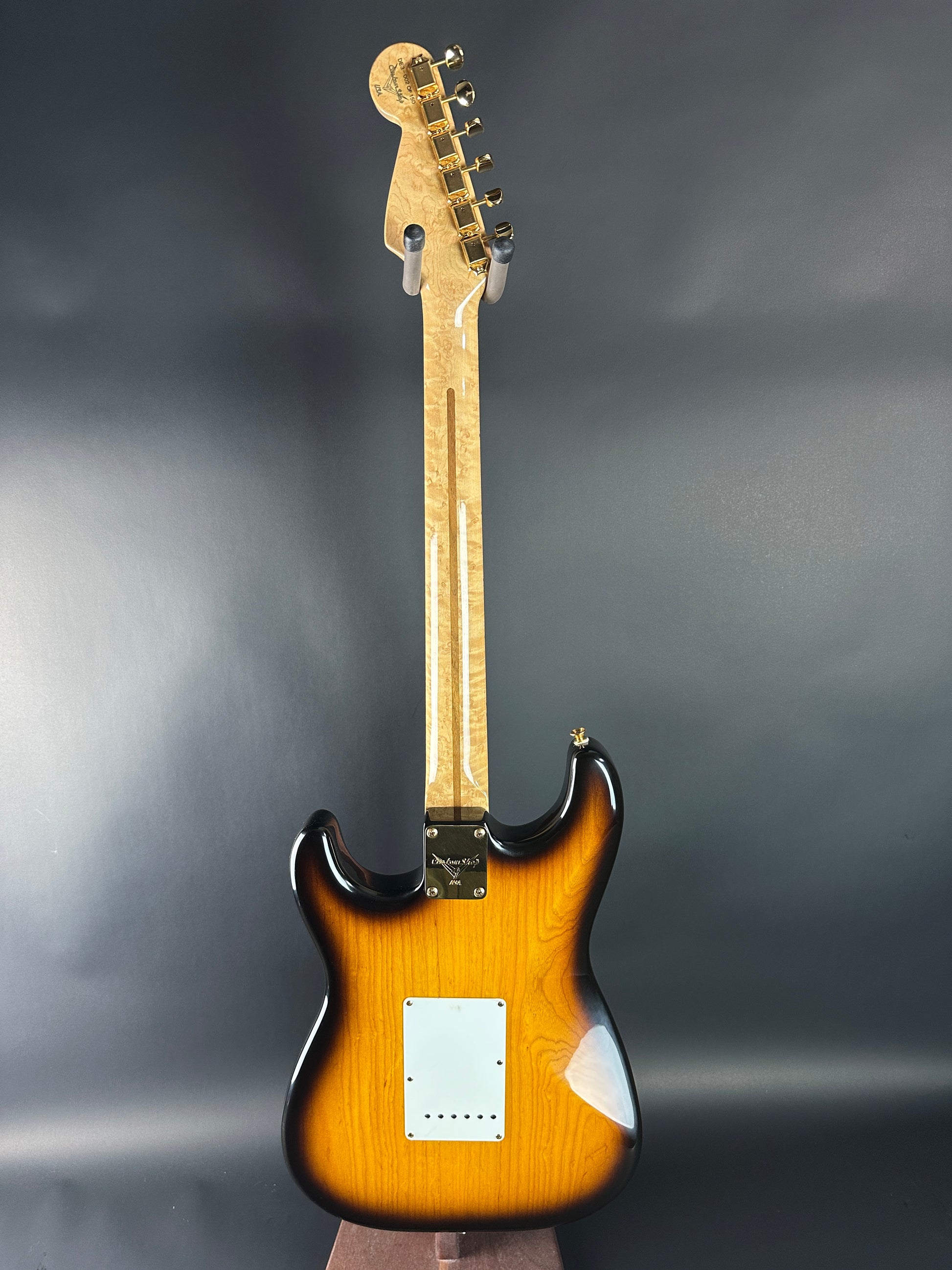 Electric guitar with a sunburst finish on a gray background