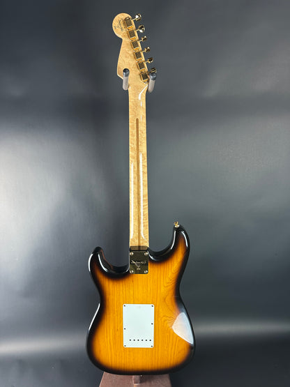 Electric guitar with a sunburst finish on a gray background