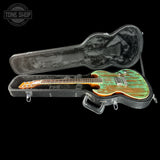 Guitar in a hard case with 'Tone Shop' logo in the corner