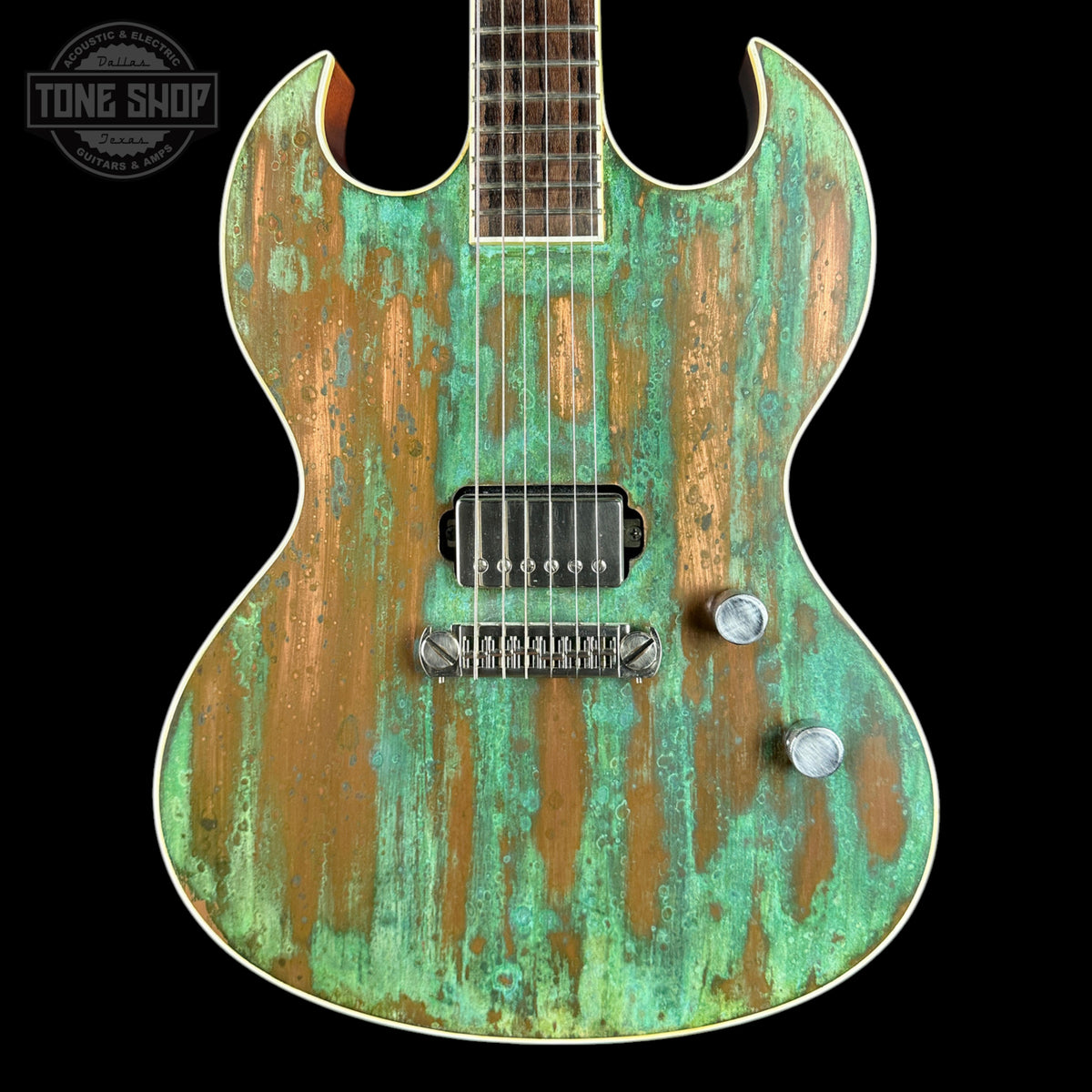 Distressed green and brown electric guitar on a black background with 'Tone Shop' logo.