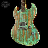 Glossy electric guitar with a green and brown distressed finish on a black background, featuring 'Tone Shop' branding.