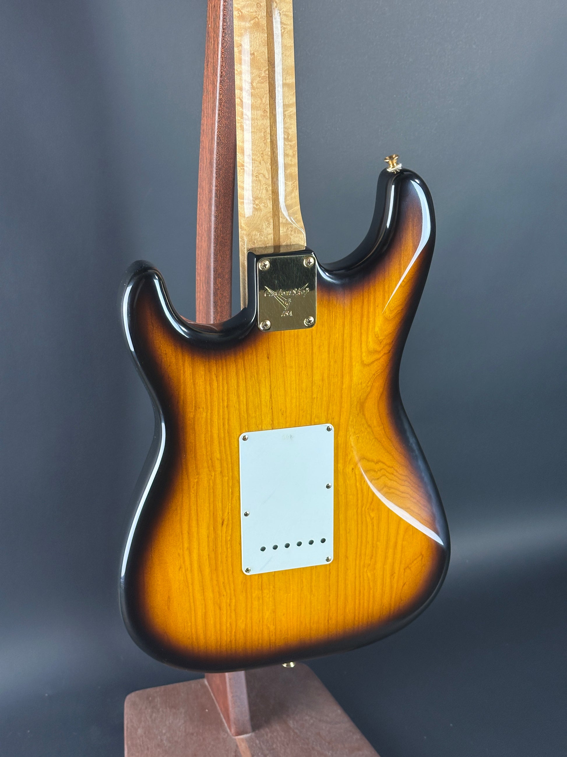 Guitar body with a sunburst finish on a dark background