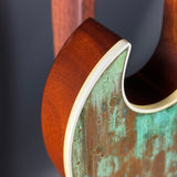 Close-up of a guitar neck with a textured finish on a dark background