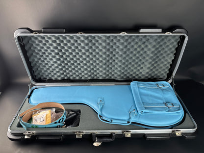 Open protective case with blue interior and gray foam lining on a dark background