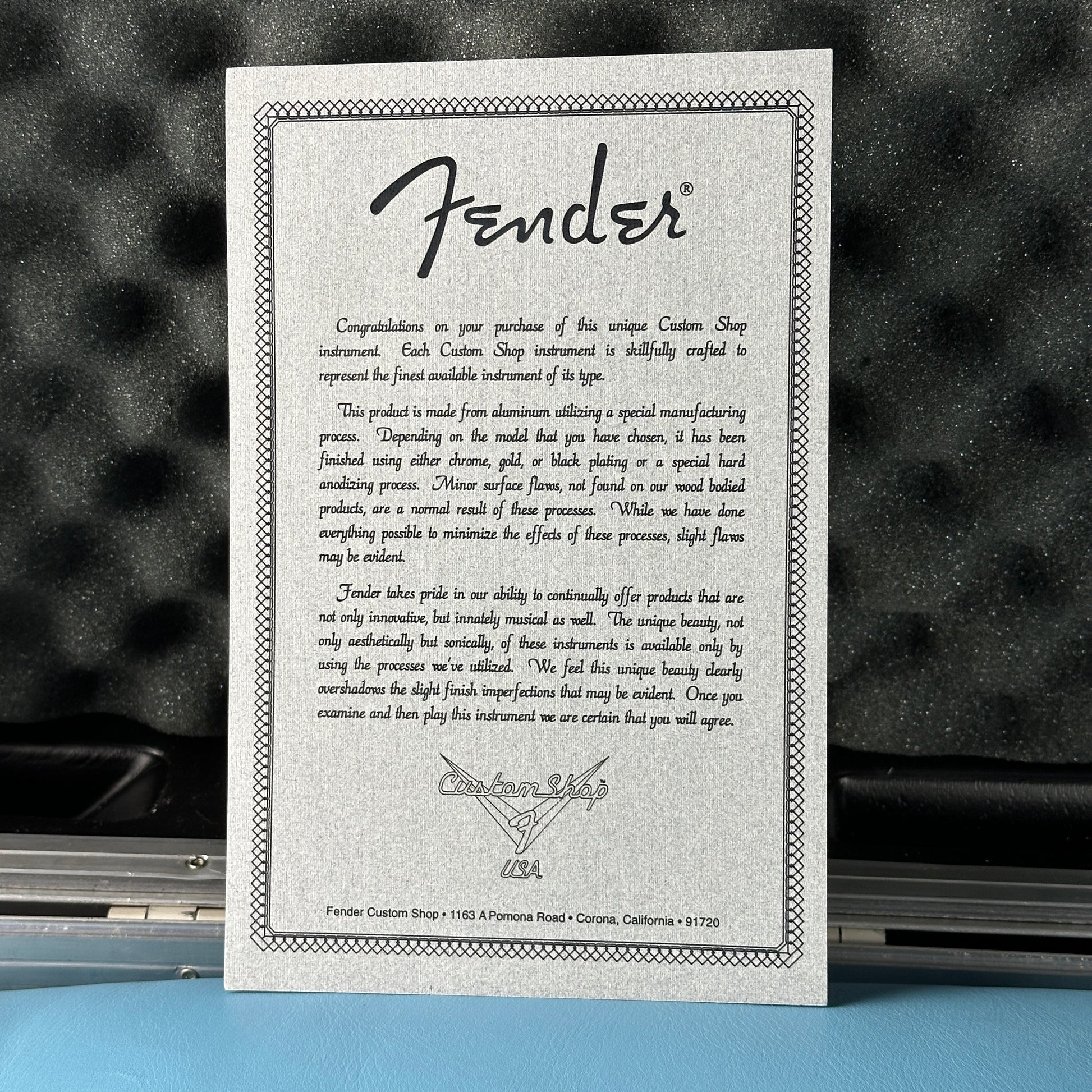 Fender Custom Shop certificate on a guitar with a blurred background