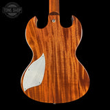 Wooden guitar body with a brand logo in the corner
