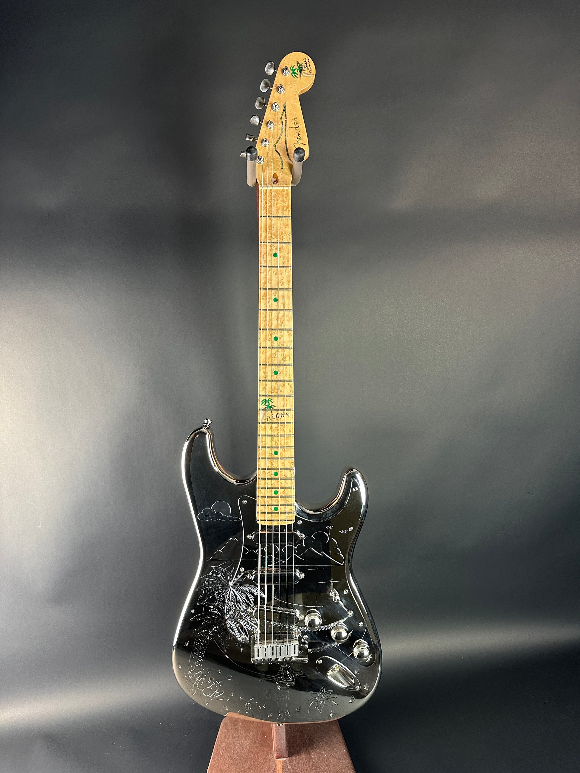 Electric guitar with a black pickguard on a gray background