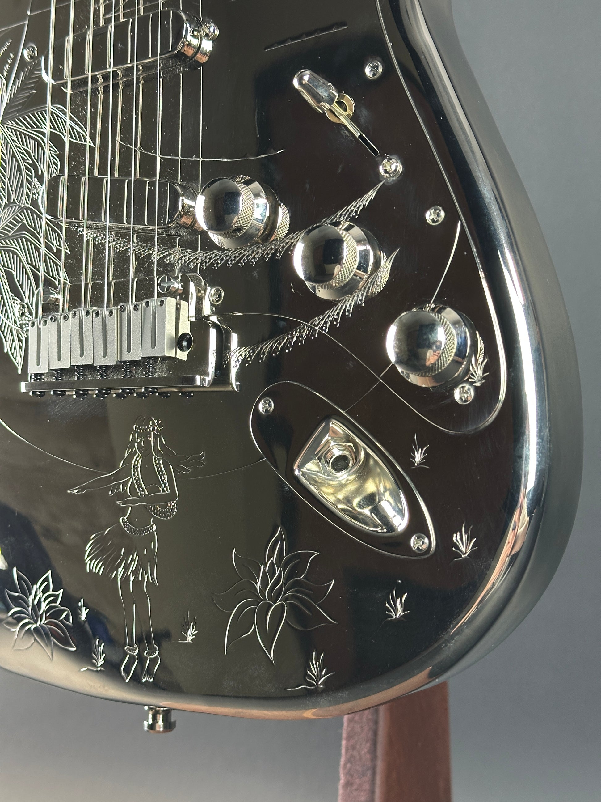 Close-up of a detailed metal object with engraved designs on a gray background