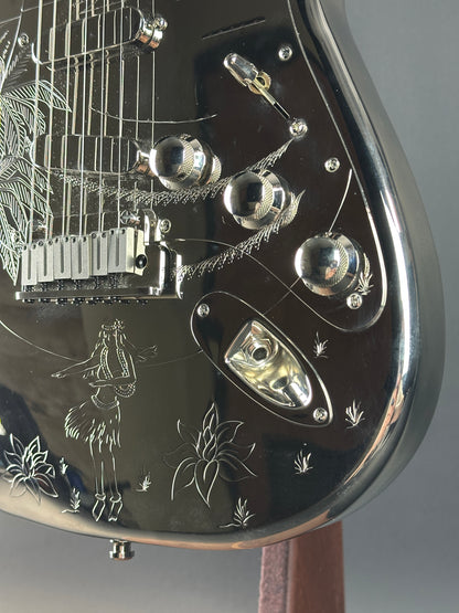 Close-up of a detailed metal object with engraved designs on a gray background