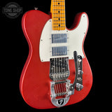 A red electric guitar with a white pickguard, maple neck, and chrome hardware, photographed against a black background with a Tone Shop watermark in the top left corner.