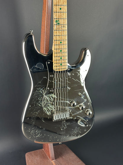 Glossy electric guitar with a detailed design on a dark background