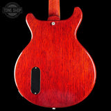 Red electric guitar body with 'Tone Shop' logo in the corner
