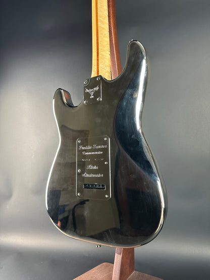 Close-up of a guitar's metallic body with a blurred background