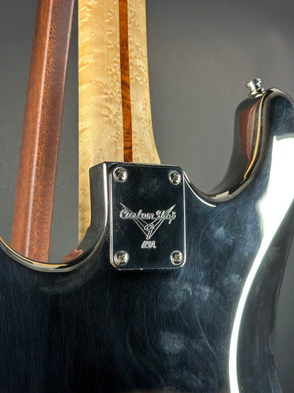 Close-up of a guitar with a visible brand logo on the headstock.