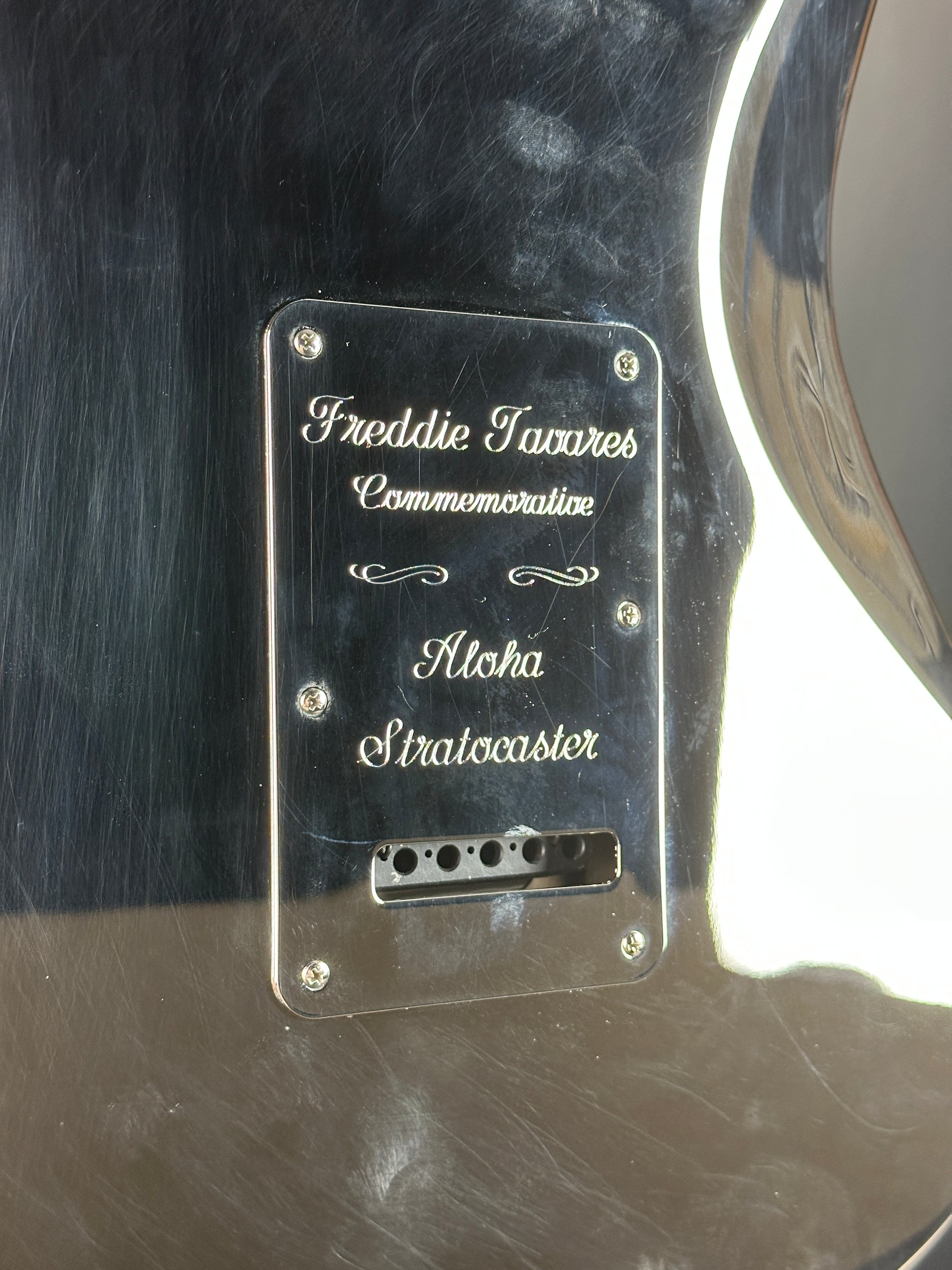 Guitar pickguard with engraved text on a guitar body