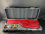 Red guitar case with accessories inside on a gray background