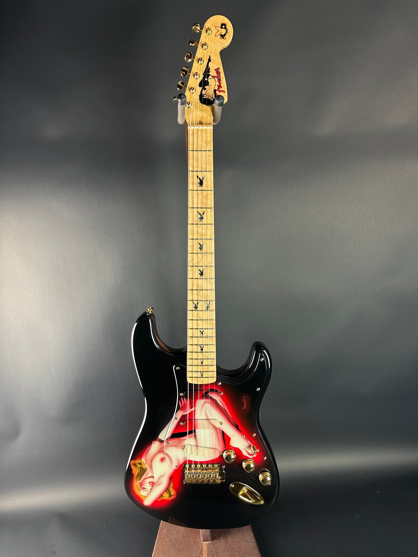 Electric guitar with a black and red design on a gray background